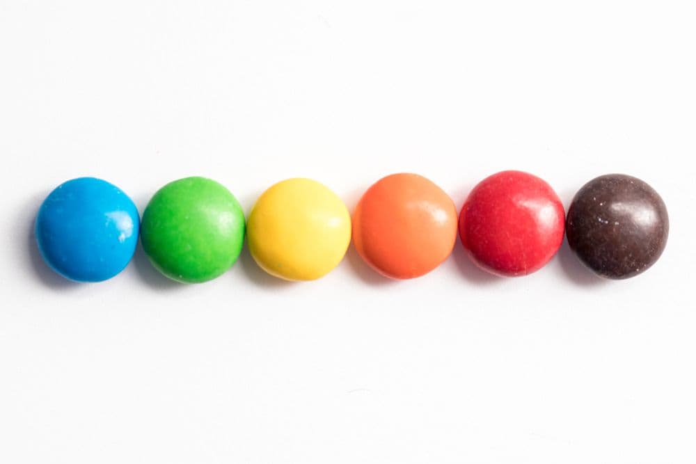 Six M&Ms of different colors lined up, representing low cardinality.